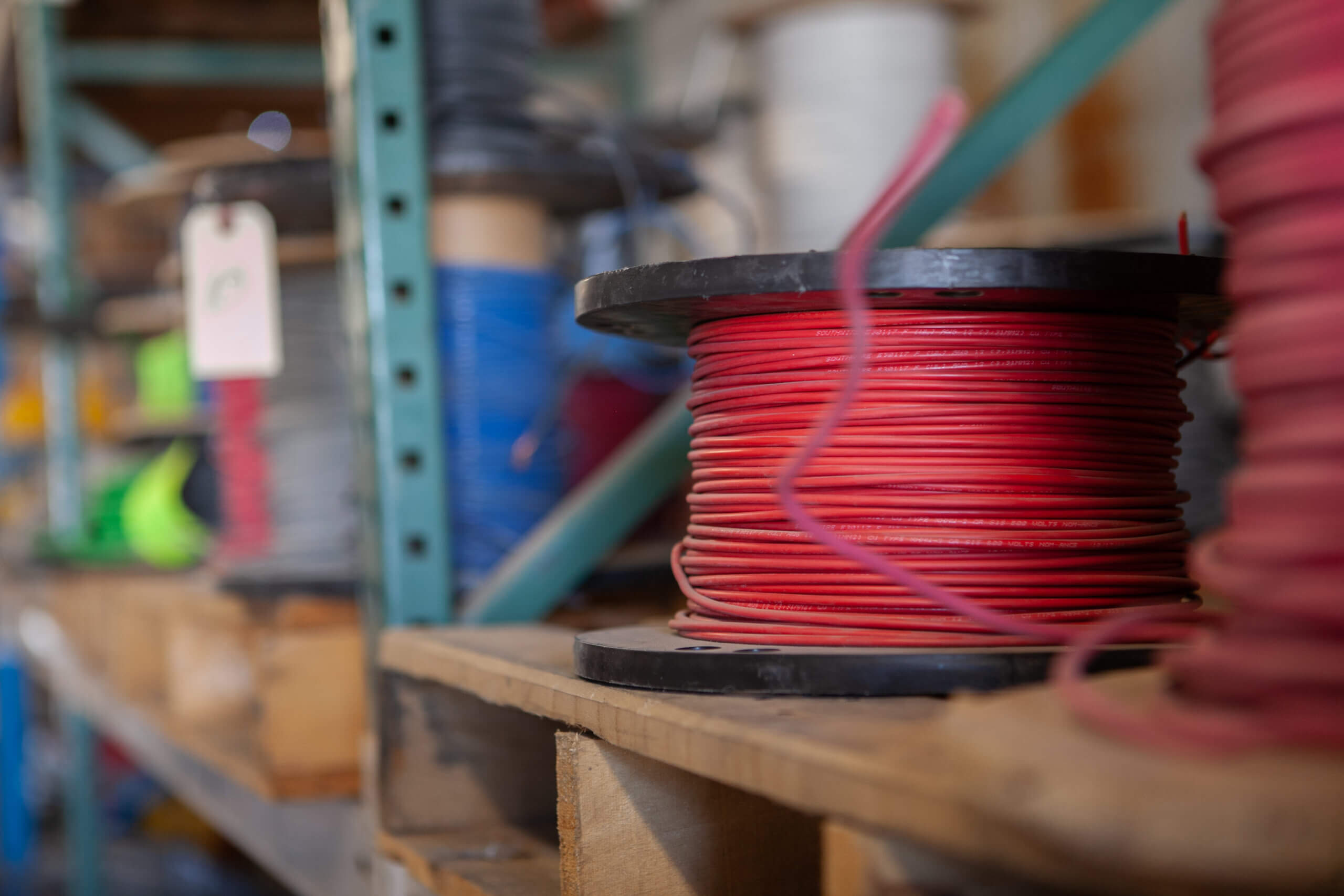Red electrical wire stacked on a shelf at Cascade Electric